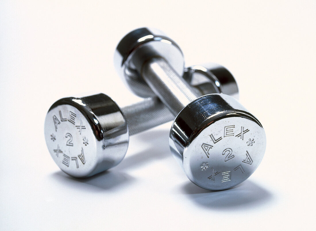 Close-up of two pound silver dumbbells on white background