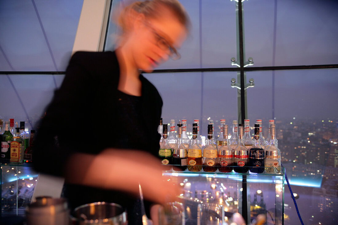 Waitress at bar counter of City Space Bar in Swissotel, Moscow, Russia, Blur