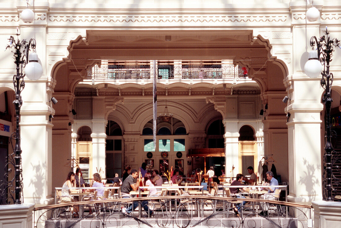 People relaxing at outdoor cafe in GUM department store, Moscow, Russia