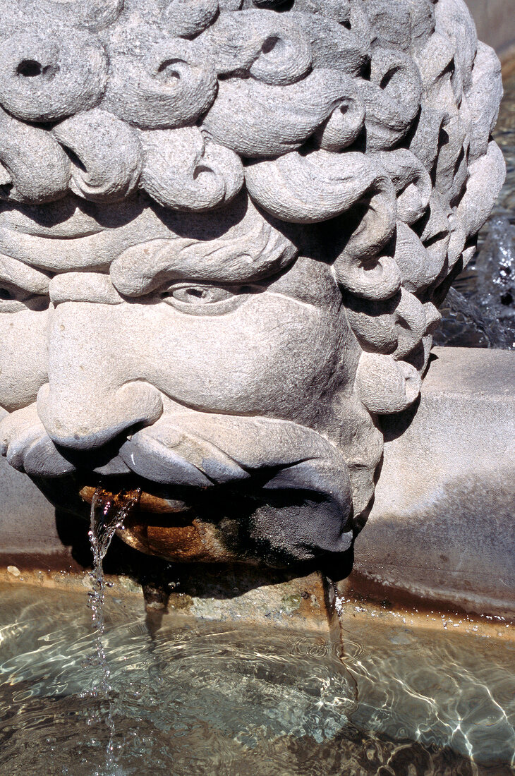 Gargoyle fountain in the shape of a man's head