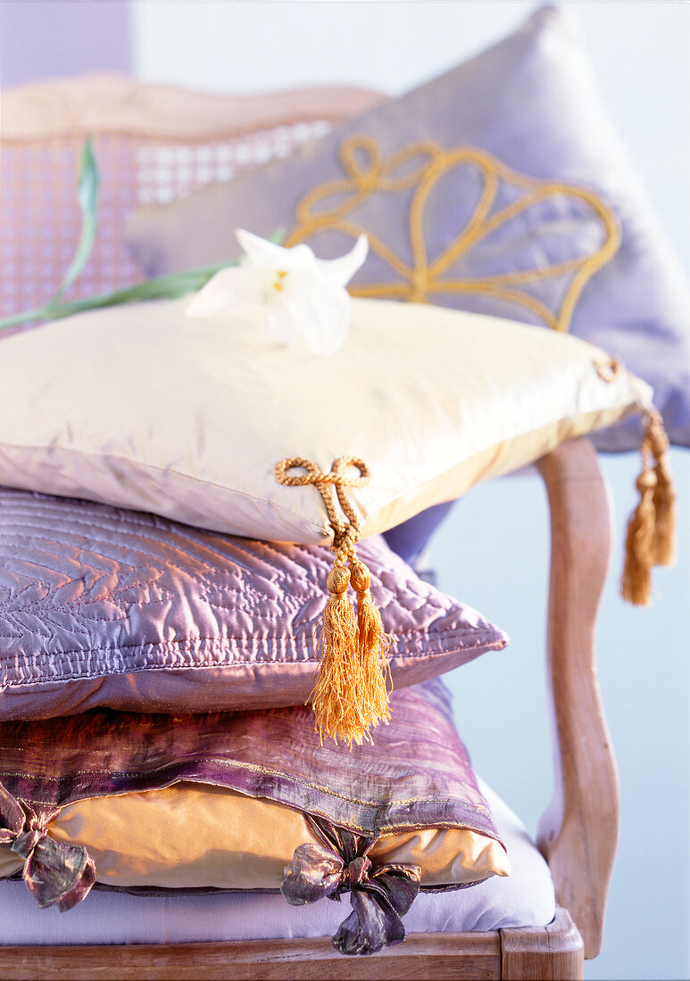 Close-up of purple oriental stacked cushions on chair
