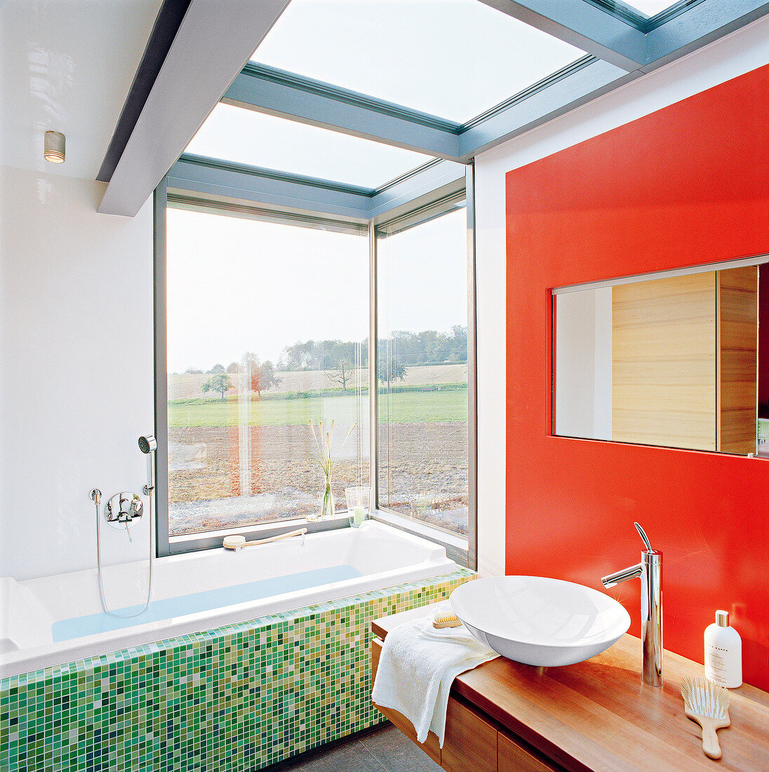Luxury bathroom with glass roof and basin in front of orange wall