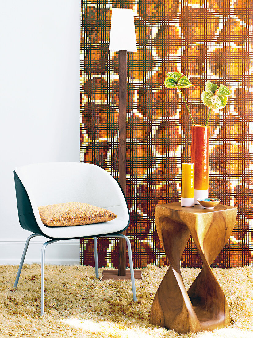Giraffe skin patterned mosaic stone on wall with stool in front