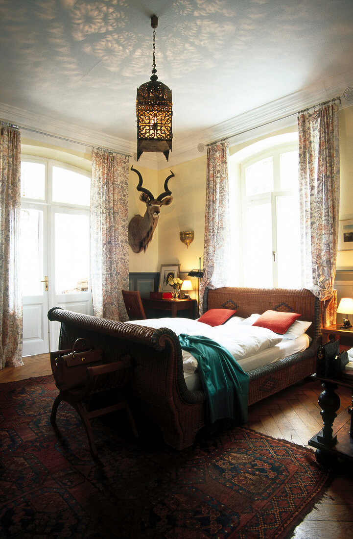 Bedroom with wicker bed and Antiquesin Villa Barleben, Germany