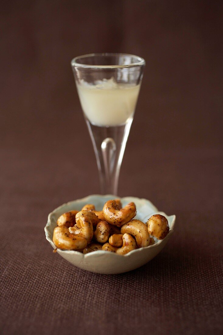 Caramelized cashews with chilled aperitif pastis drink