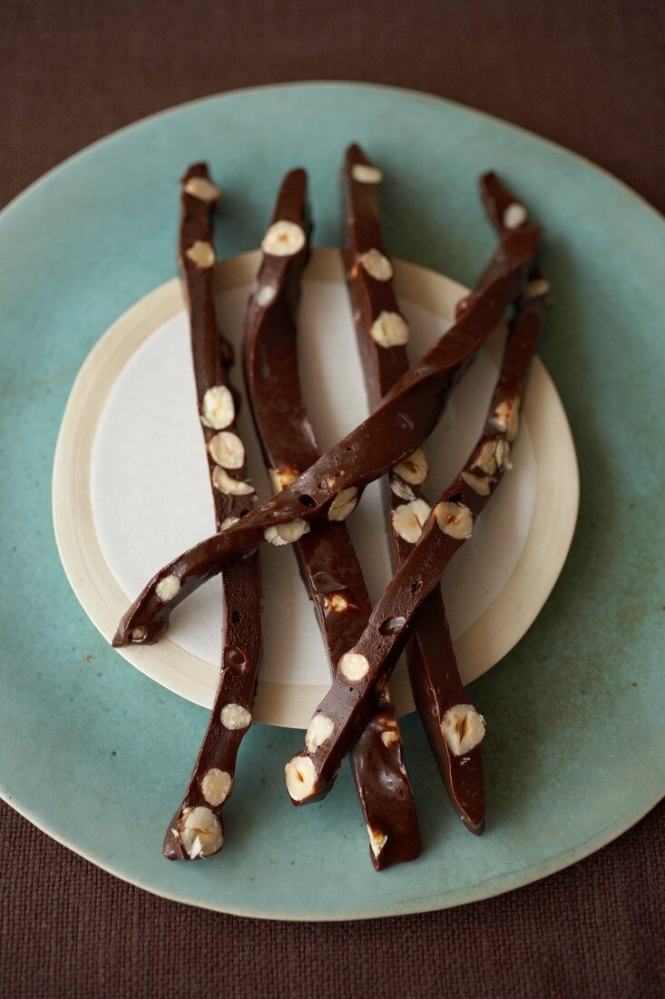 Chocolate with coffee, hazelnuts and caramels on plate