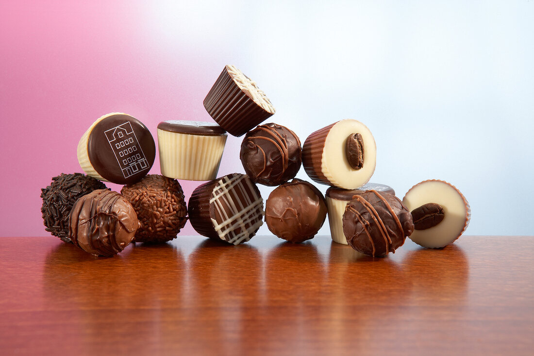 Variety of coffee chocolate and coffee truffles kept on wooden table