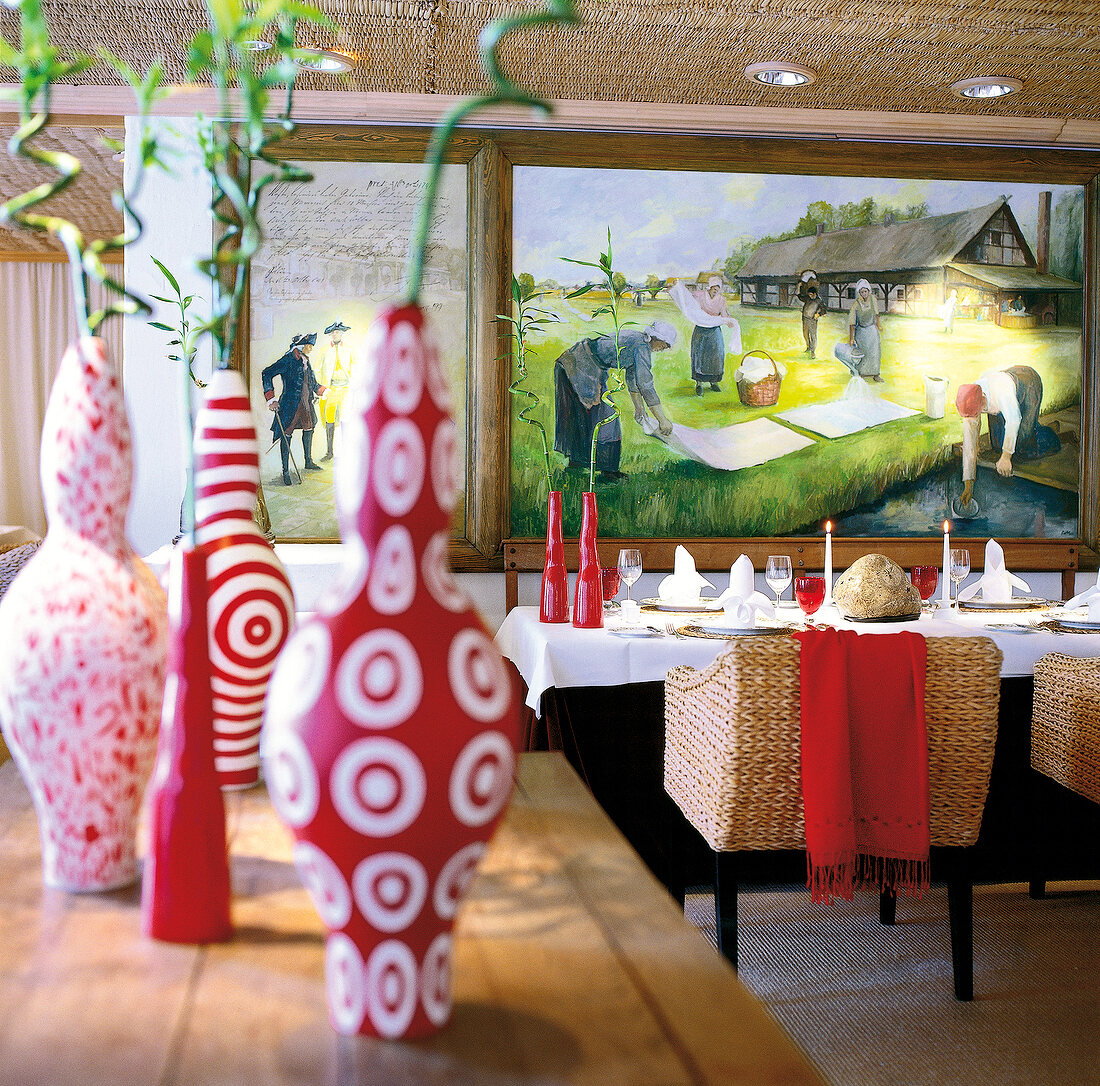 Table setting, wall painting depicting working women and vase on wooden table