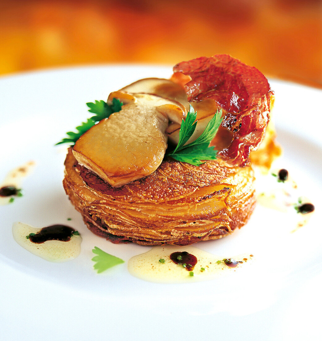 Close-up of potato tart with mushrooms on plate