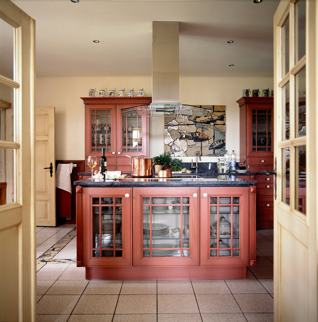 View of kitchen with red brown solid wood cabinets