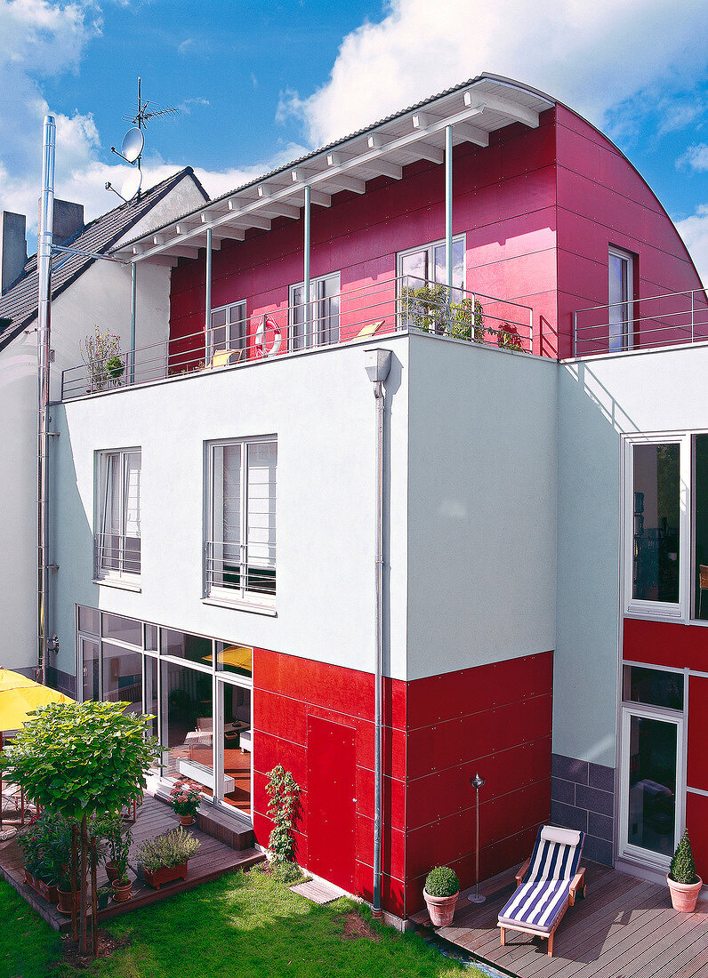 Red and white three storied semi-detached house with terrace