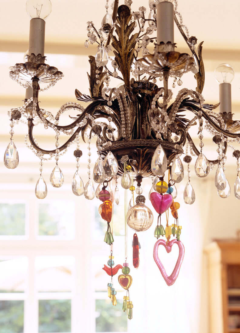 Close-up of chandelier with glass crystals and colourful accessories