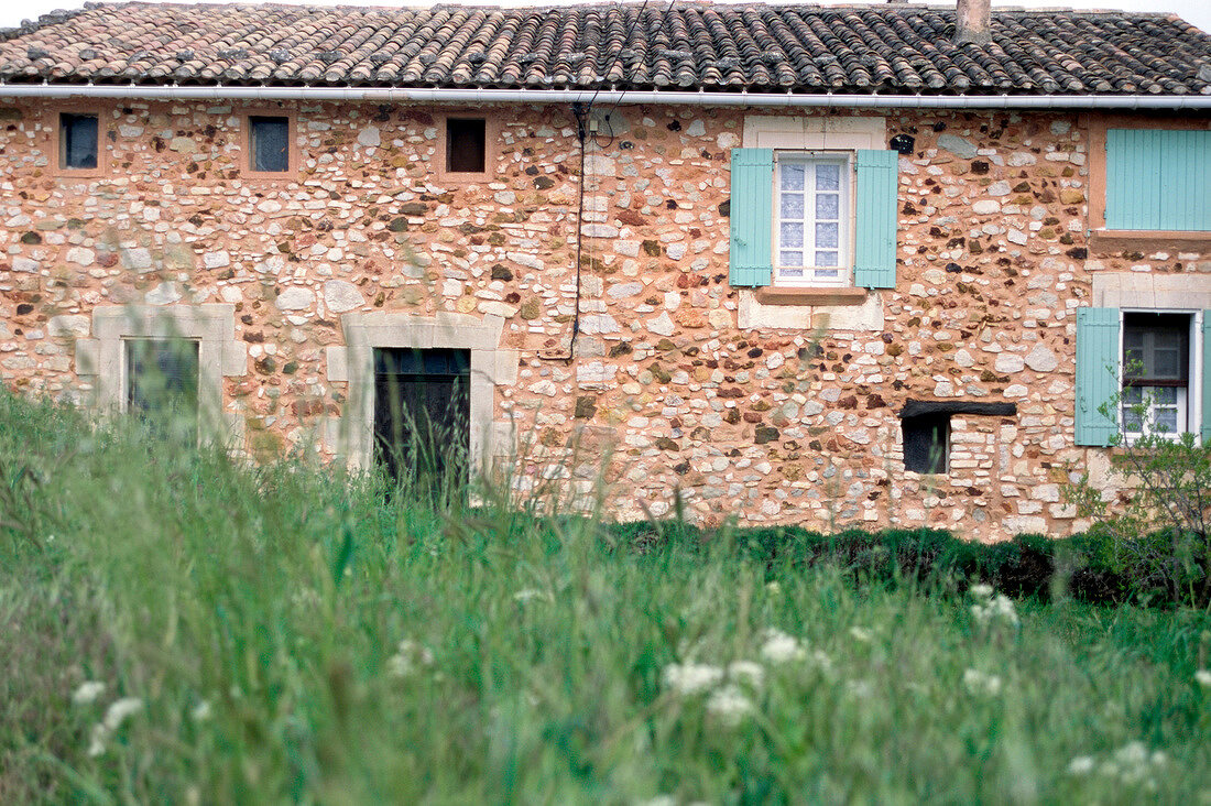 House made of stones and turquoise shutters