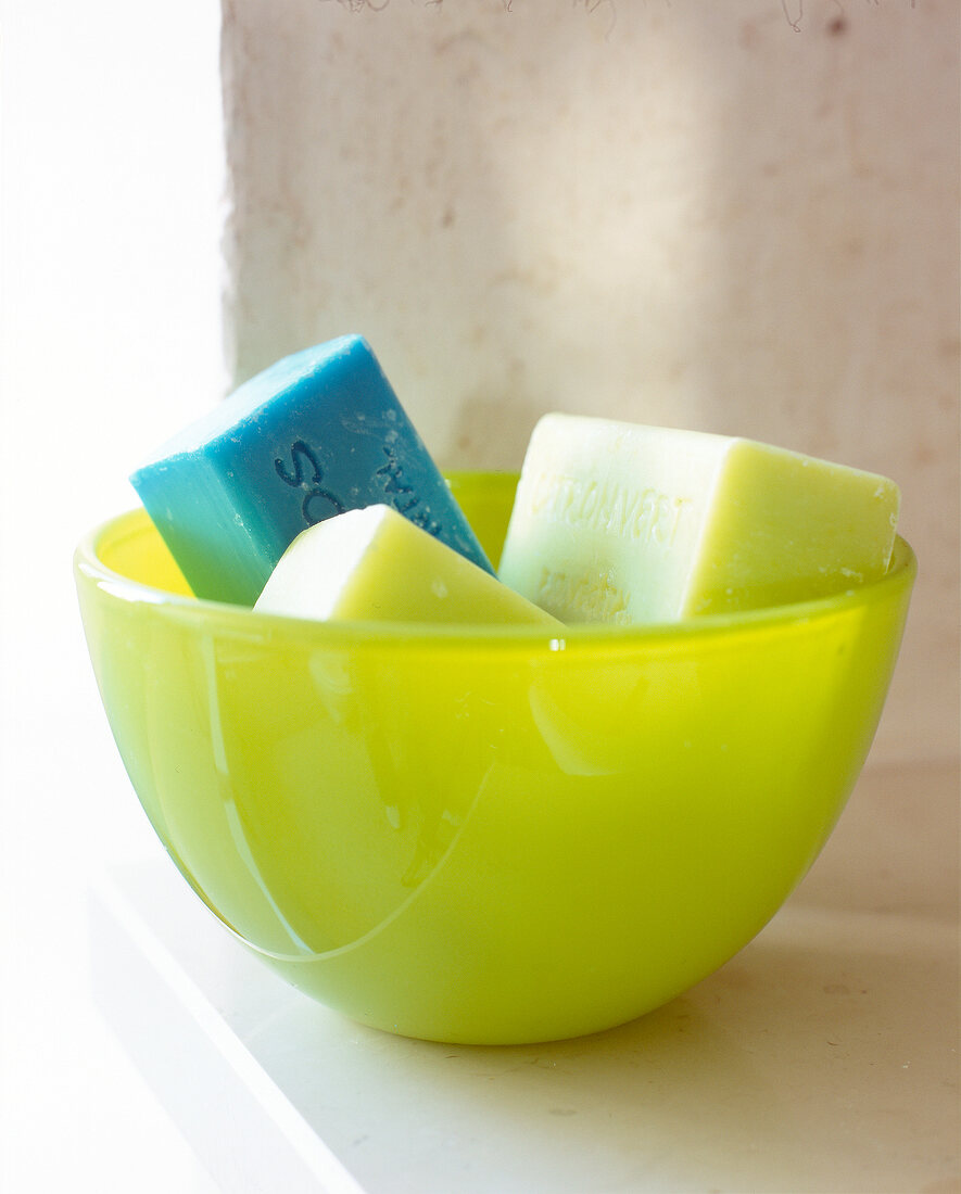 Close-up of blue and green soap in green bowl