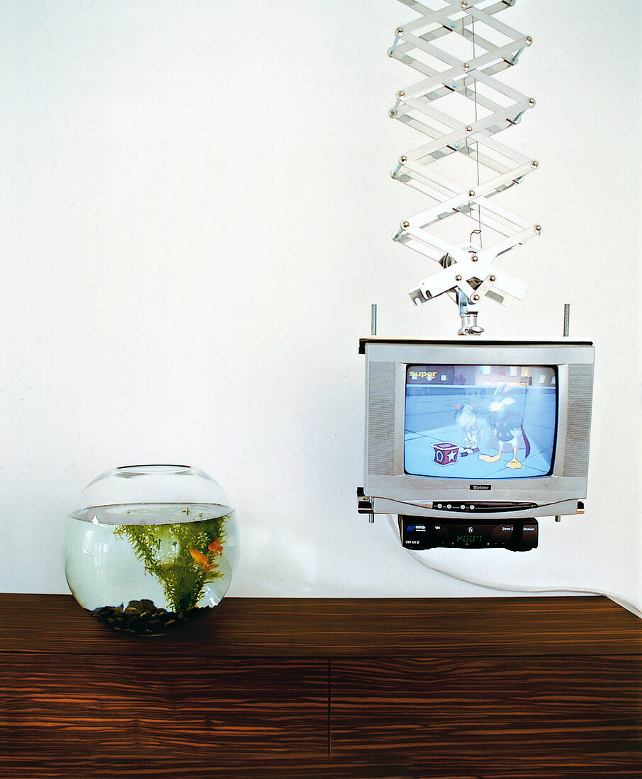 Fernseher an einer Aufhängung, daneben ein Aquarium.