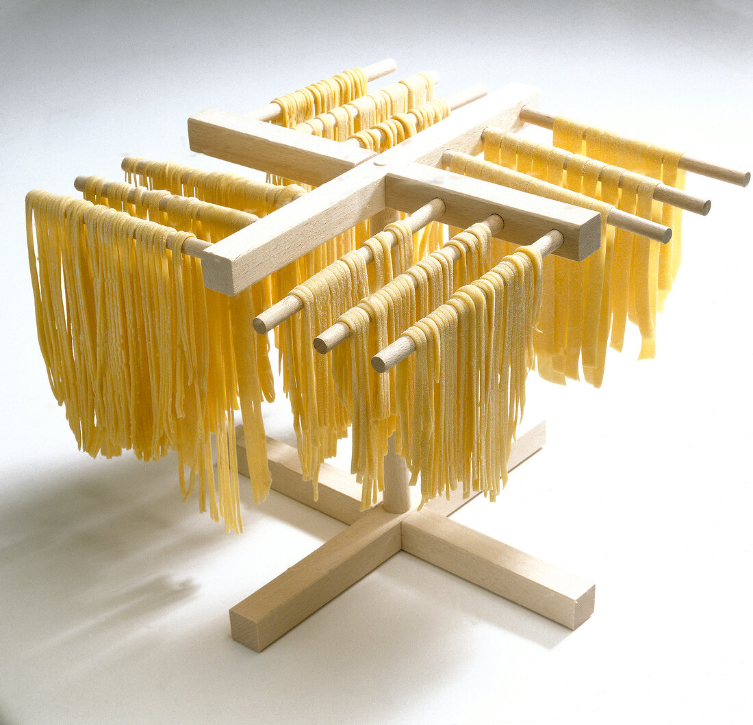 Pasta strips being dried on stand