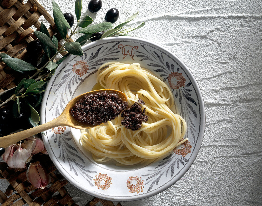 Spaghetti with olive tapenade on plate