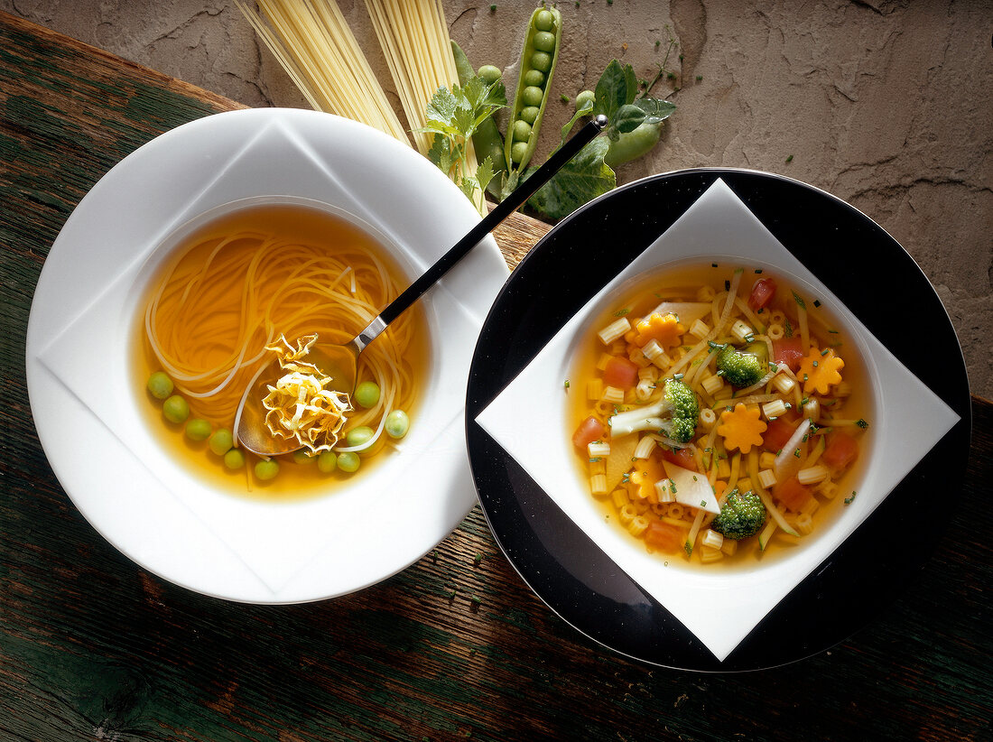 Consommes of capellini with lentils and ditali with vegetables in two bowls