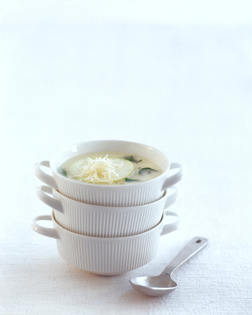 Apple soup with grated horseradish in bowl on white background