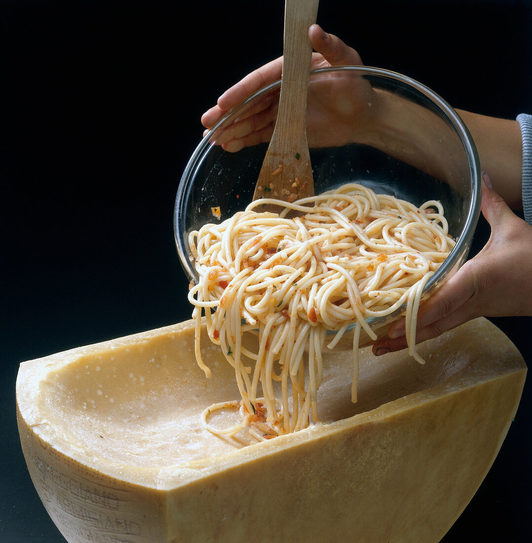 Noodles being filled in parmesan cheese, step 4