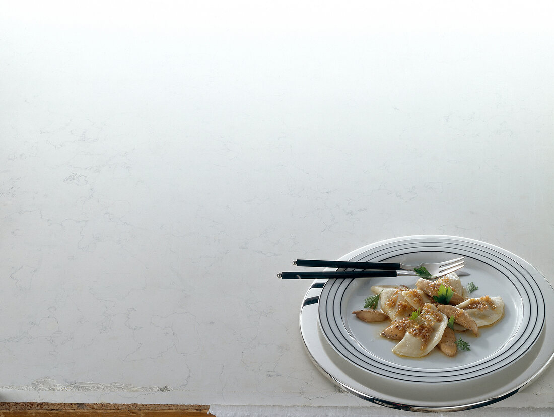 Mushroom pierogi with foie gras on plate, copy space