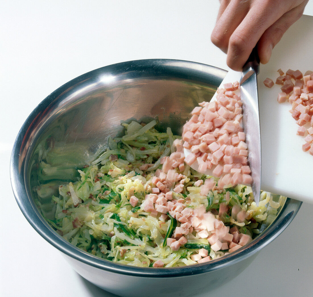 Various ingredients being added in steel bowl