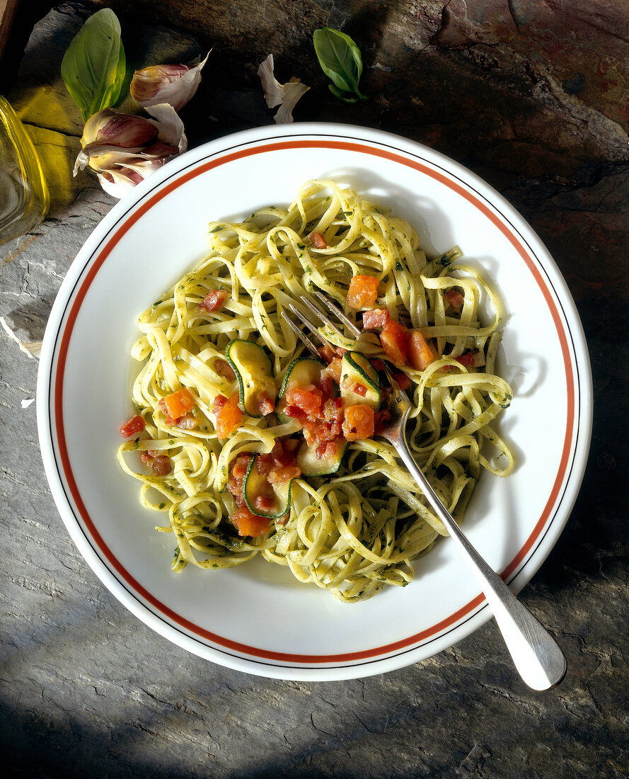 Trenette with pesto and vegetables on plate