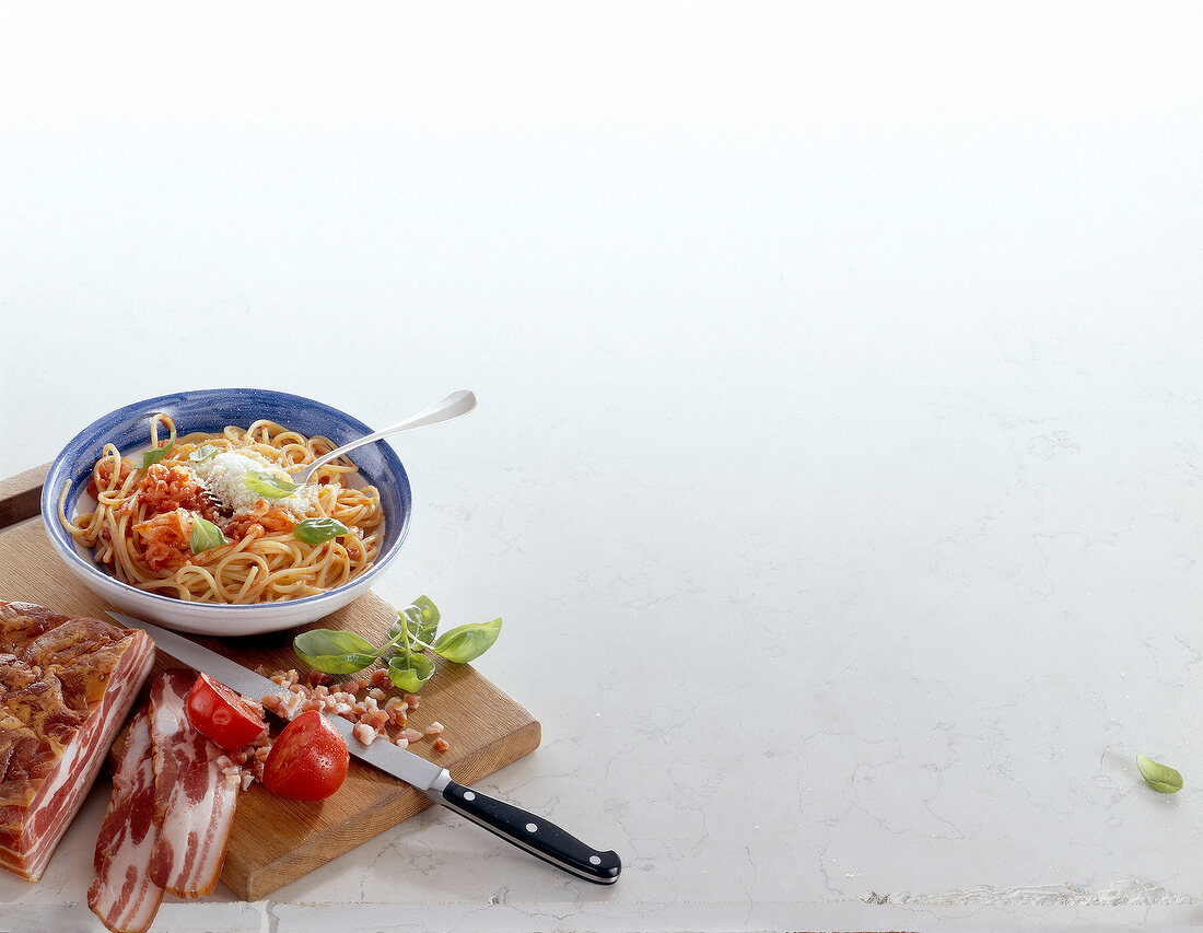 Bowl of spaghetti alla chitarra on white background, copy space