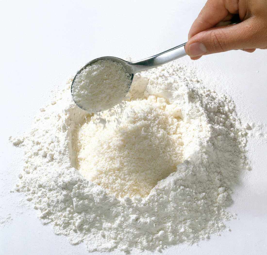 Parmesan and flour being mixed with spoon