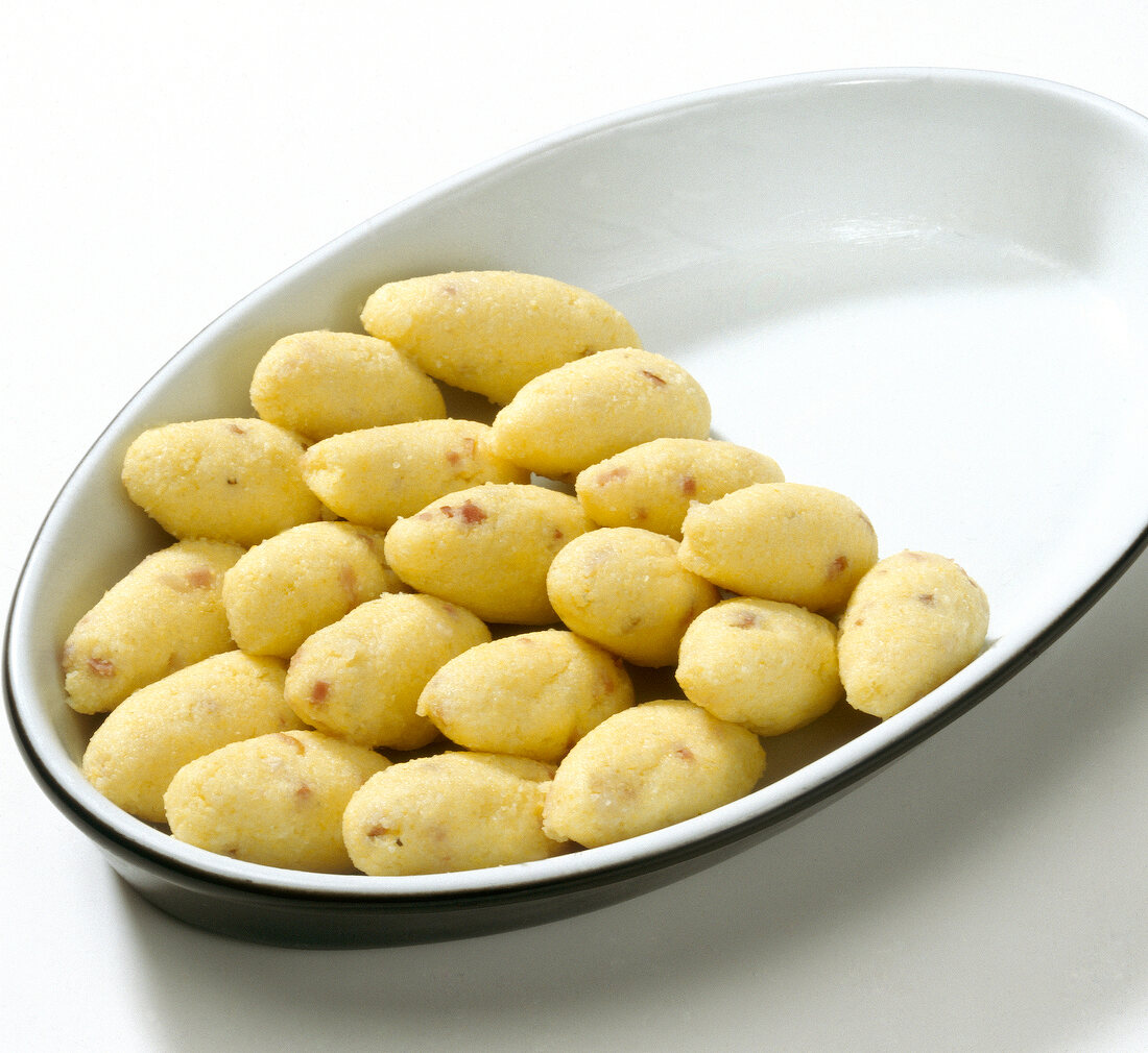 Rolled and cooked polenta on baking tray while preparing polenta gnocchi, step 3