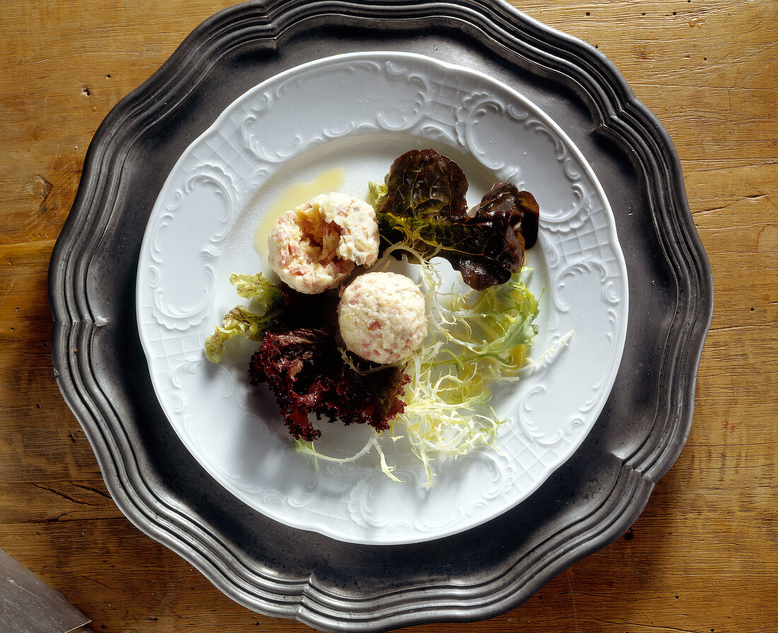 Ham dumplings with salad on plate