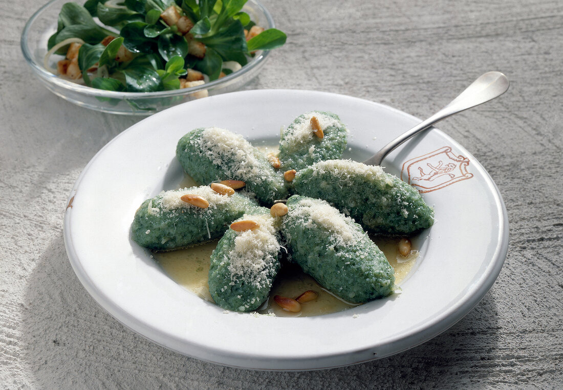 Gnocchi with parmesan and corn salad on plate