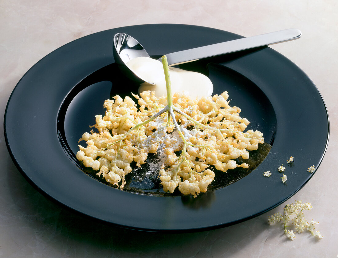 Baked elderflower on plate with spoon