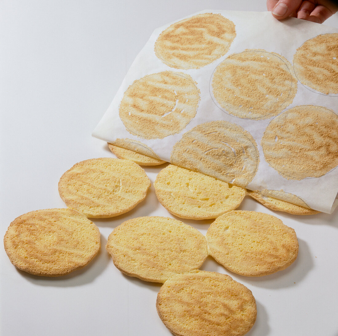 Baked biscuits being separated from baking paper