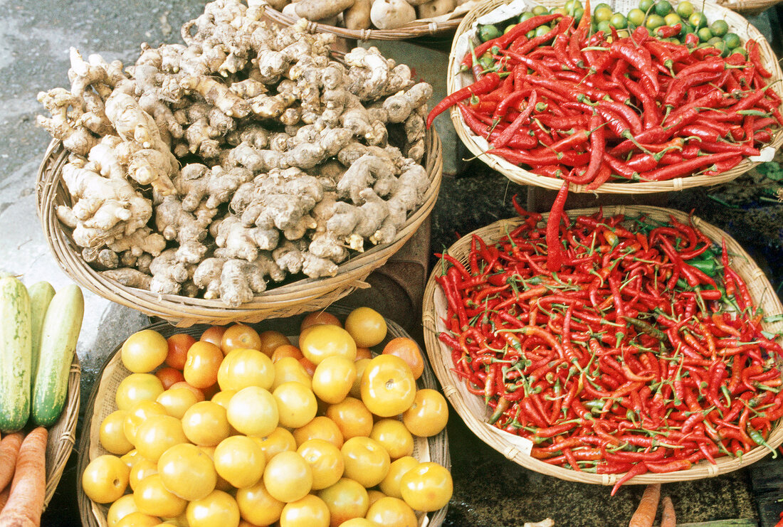 Chilli, peppers and ginger roots in baskets