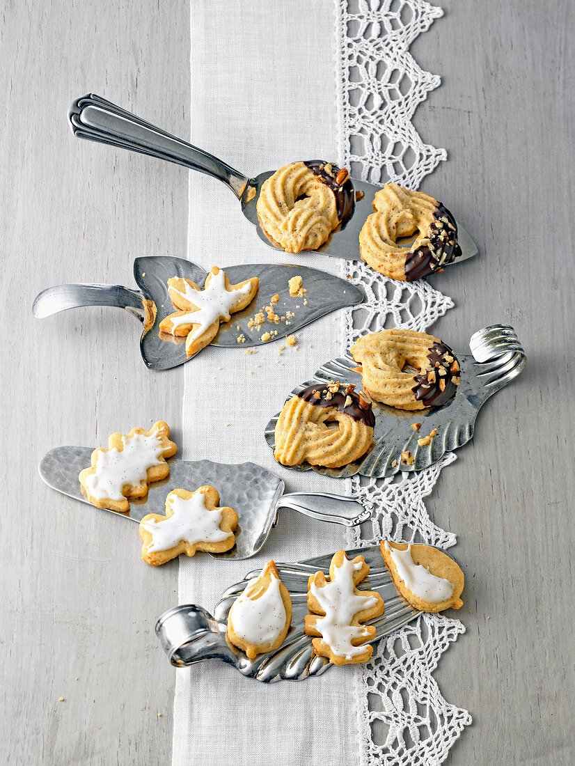 Different shaped nut kringle cookies on steel spatula