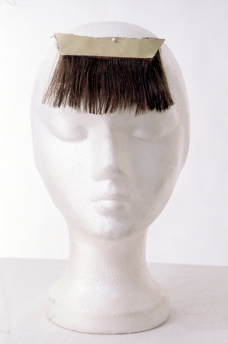 Artificial bangs with tape on head mannequin