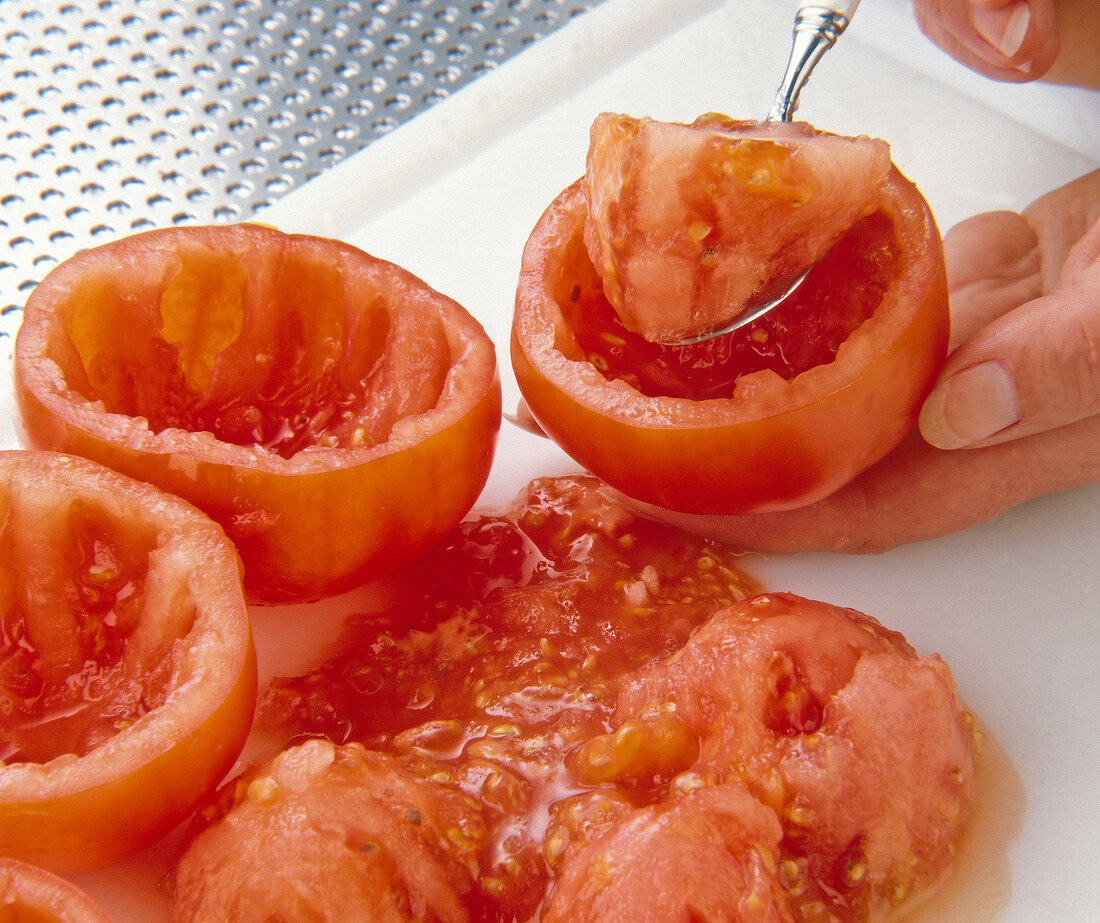 Close-up of tomatoes hollowed with a spoon scoop on plate
