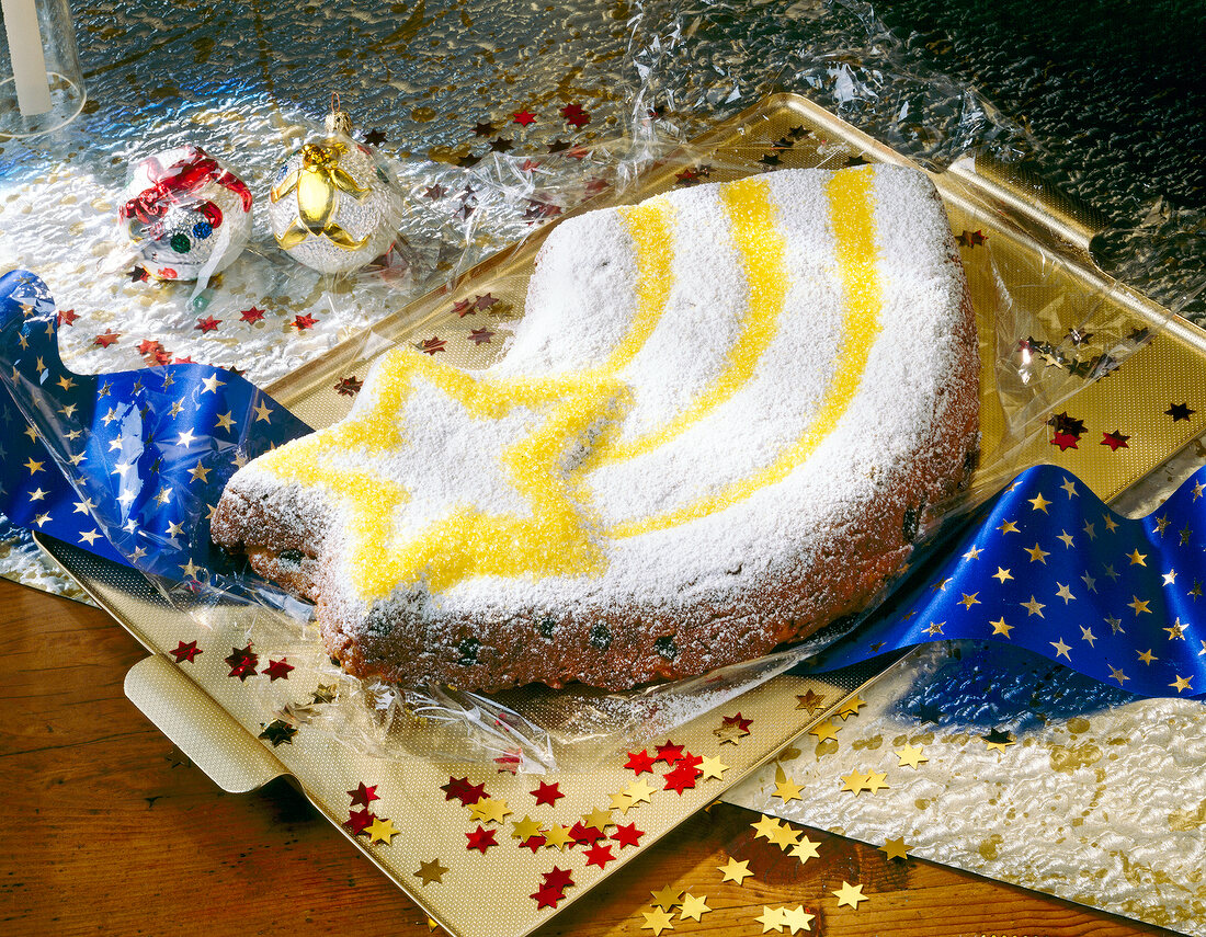 Star shaped marzipan stollen Christmas cake on tray