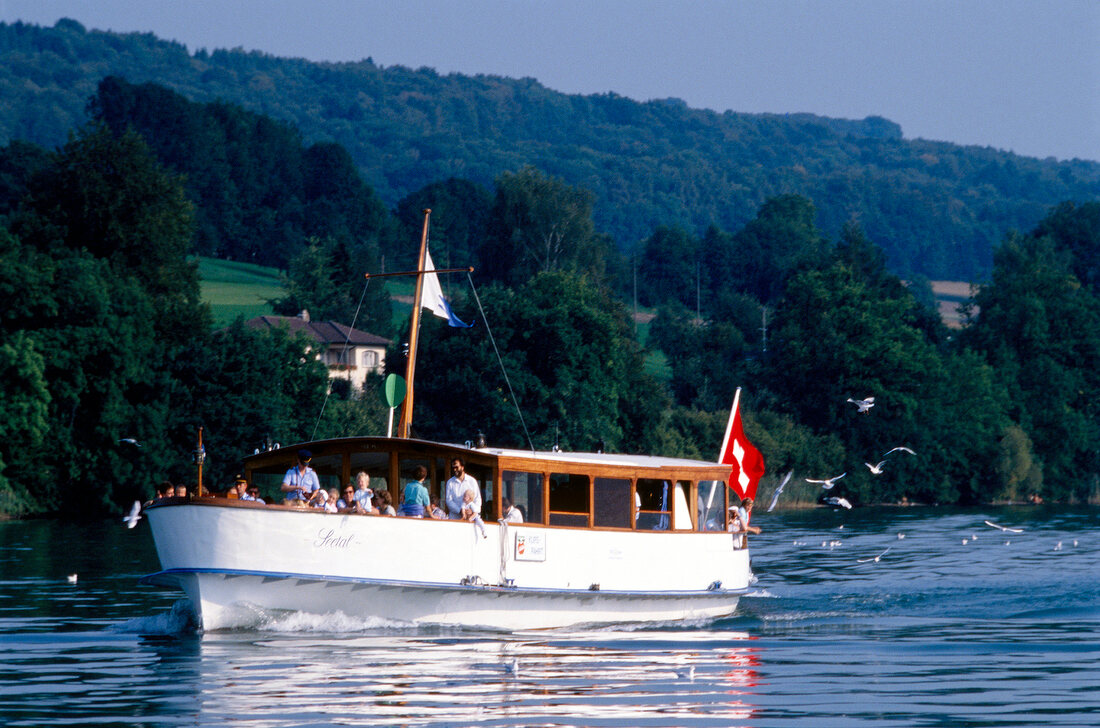 Tourists sailing on boat in Lake Hallwil, Switzerland