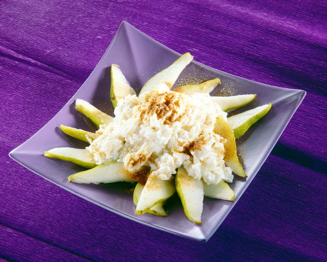 Close-up of yogurt rice with pears and cinnamon in square bowl