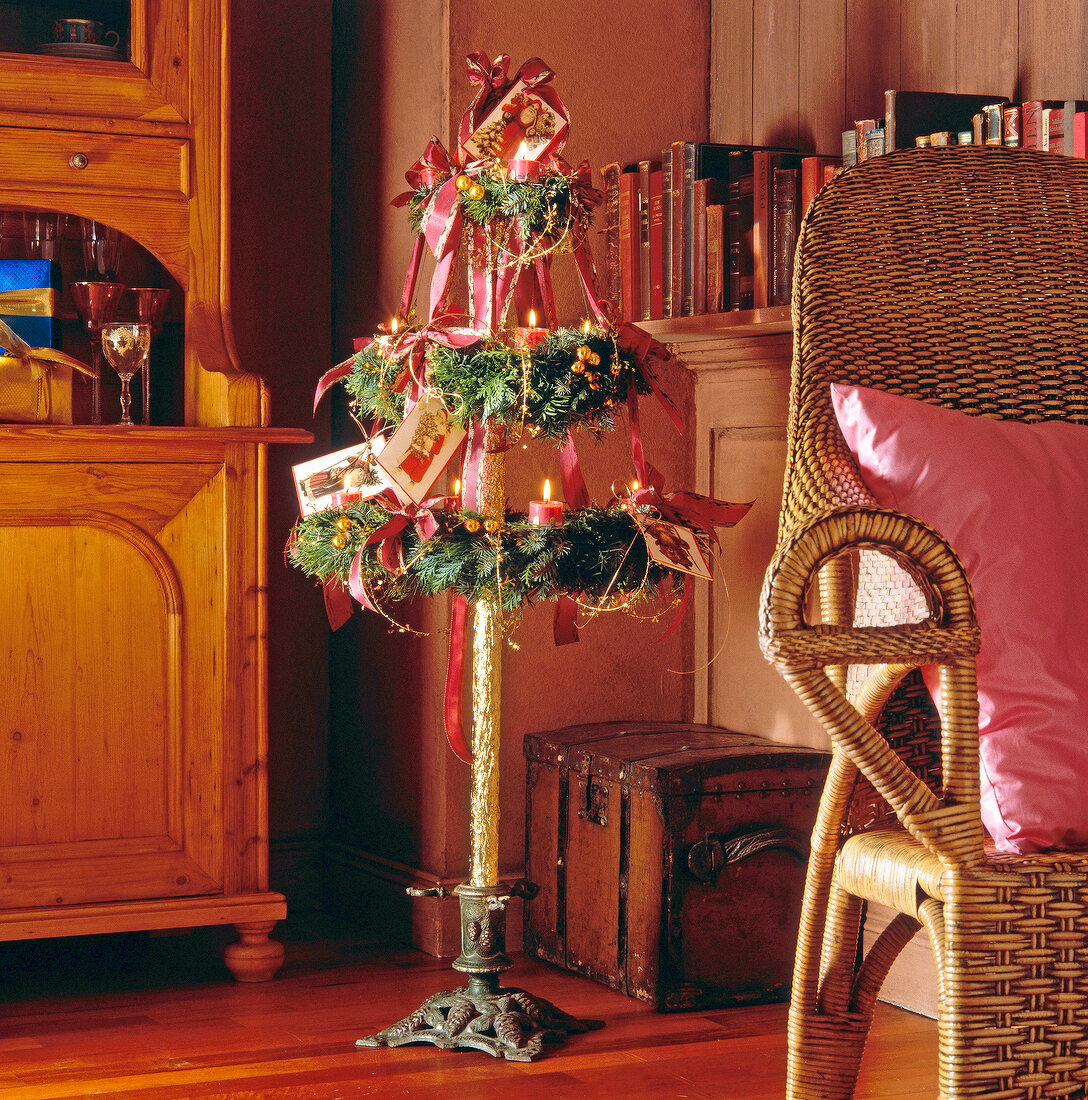 Wreath pyramid decorated with lit candles and Christmas cards