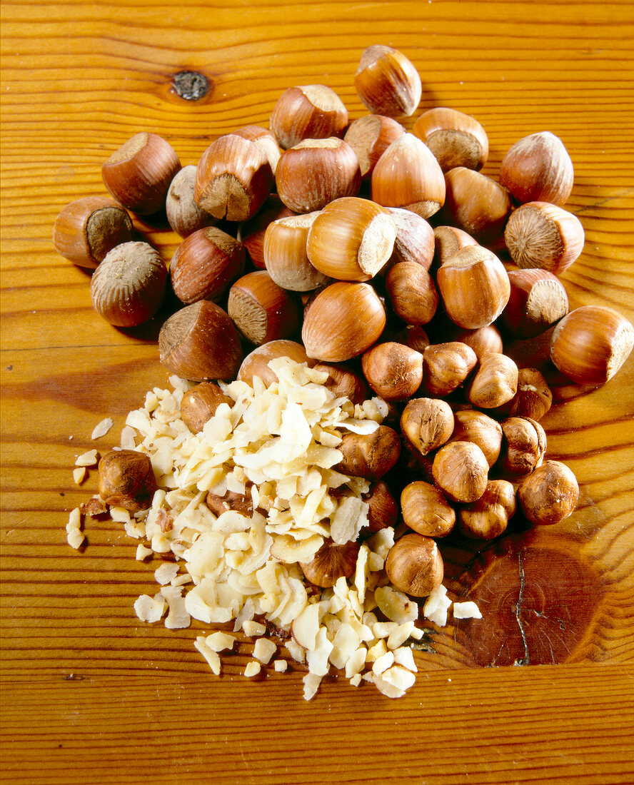 Close-up of large and small hazelnuts, chopped almonds