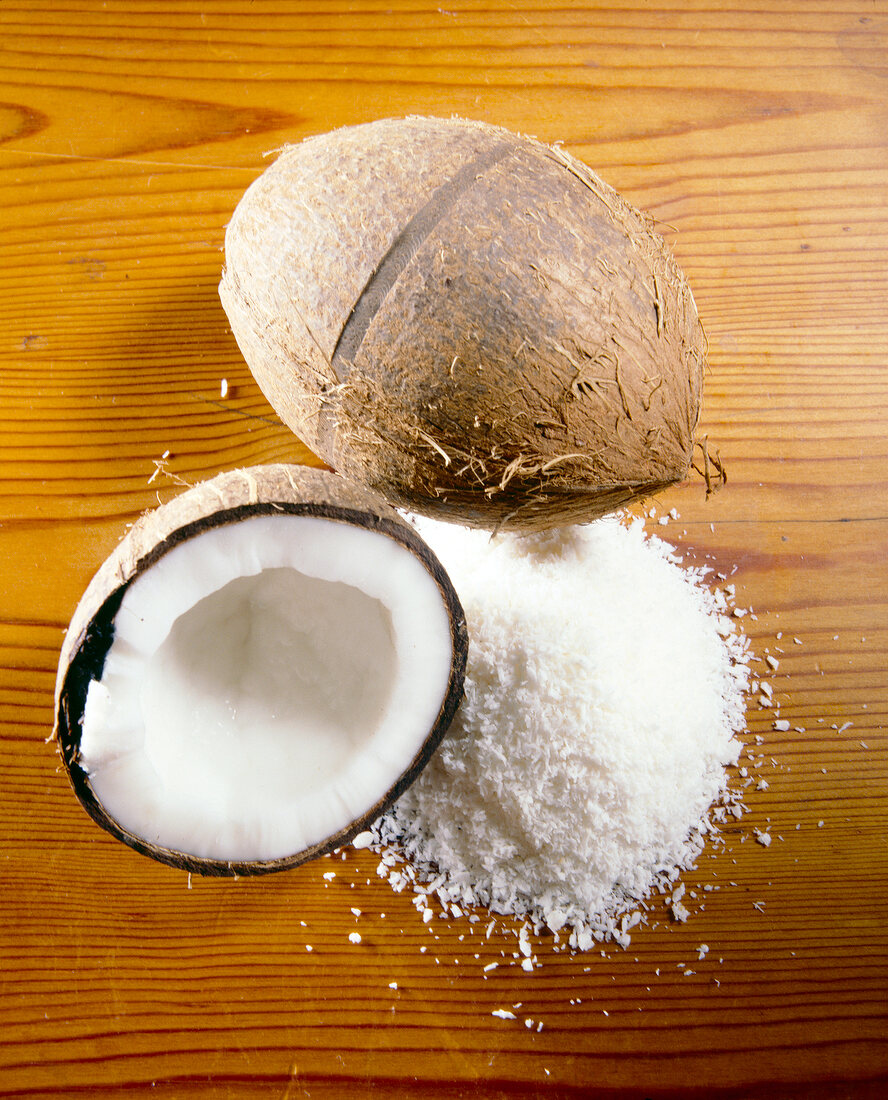 Close-up of whole, half coconut and grated coconut