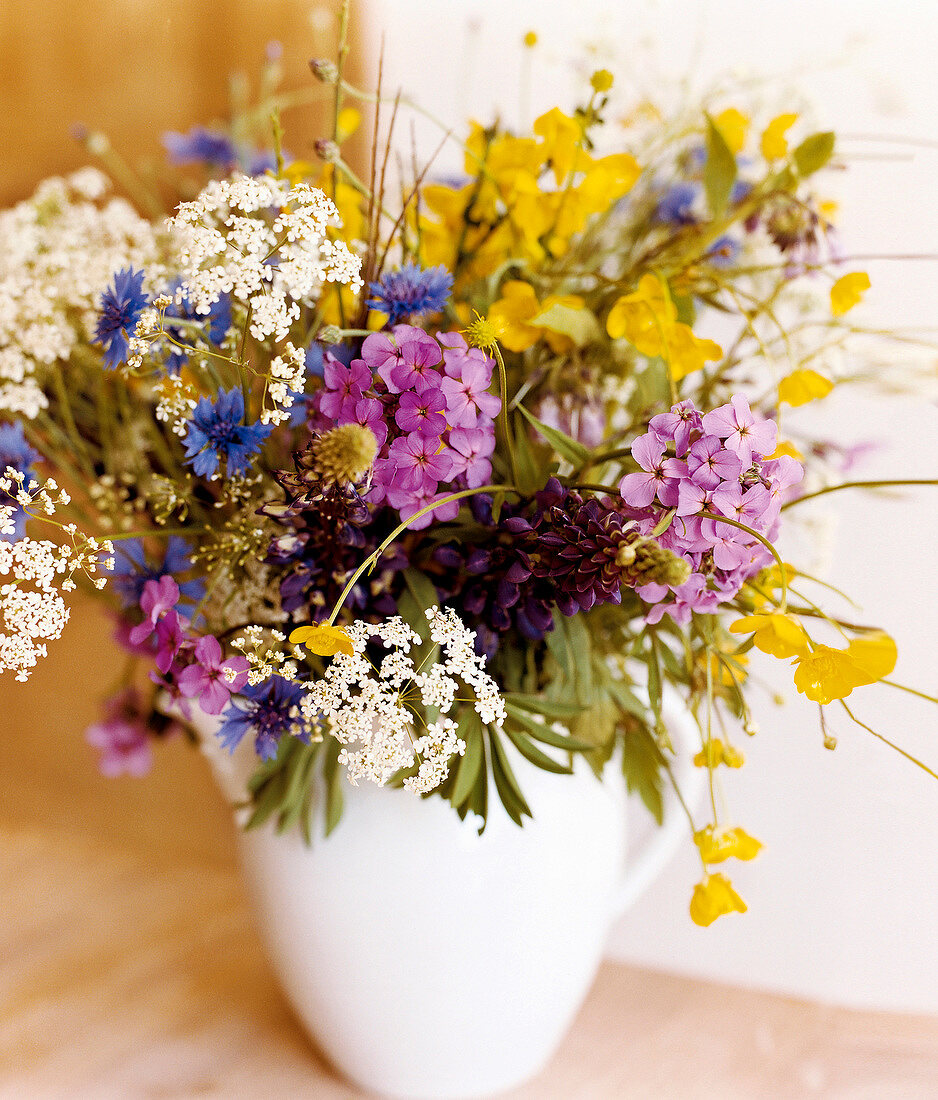 Close-up of bouquet of flowers in white vase