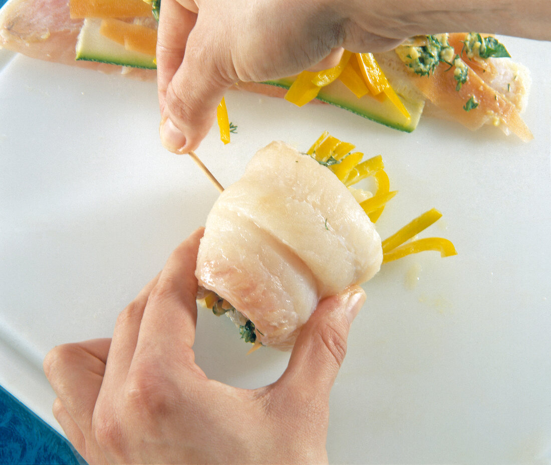 Stuffed fish fillets roll with wooden sticks stuck together