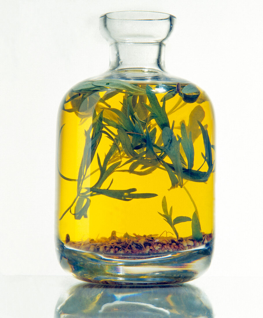Yellow vinegar with mustard, saffron and tarragon in flask