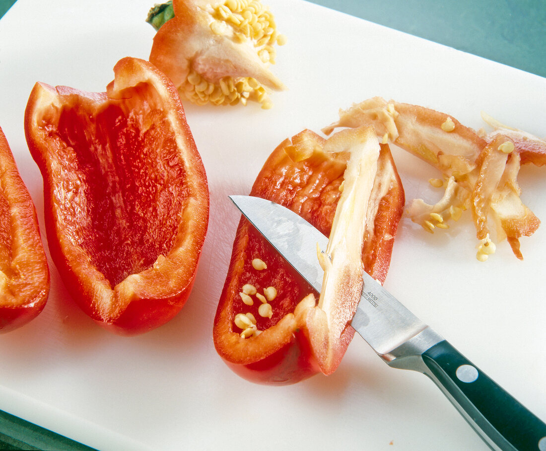 Bell pepper cut with knife on chopping board