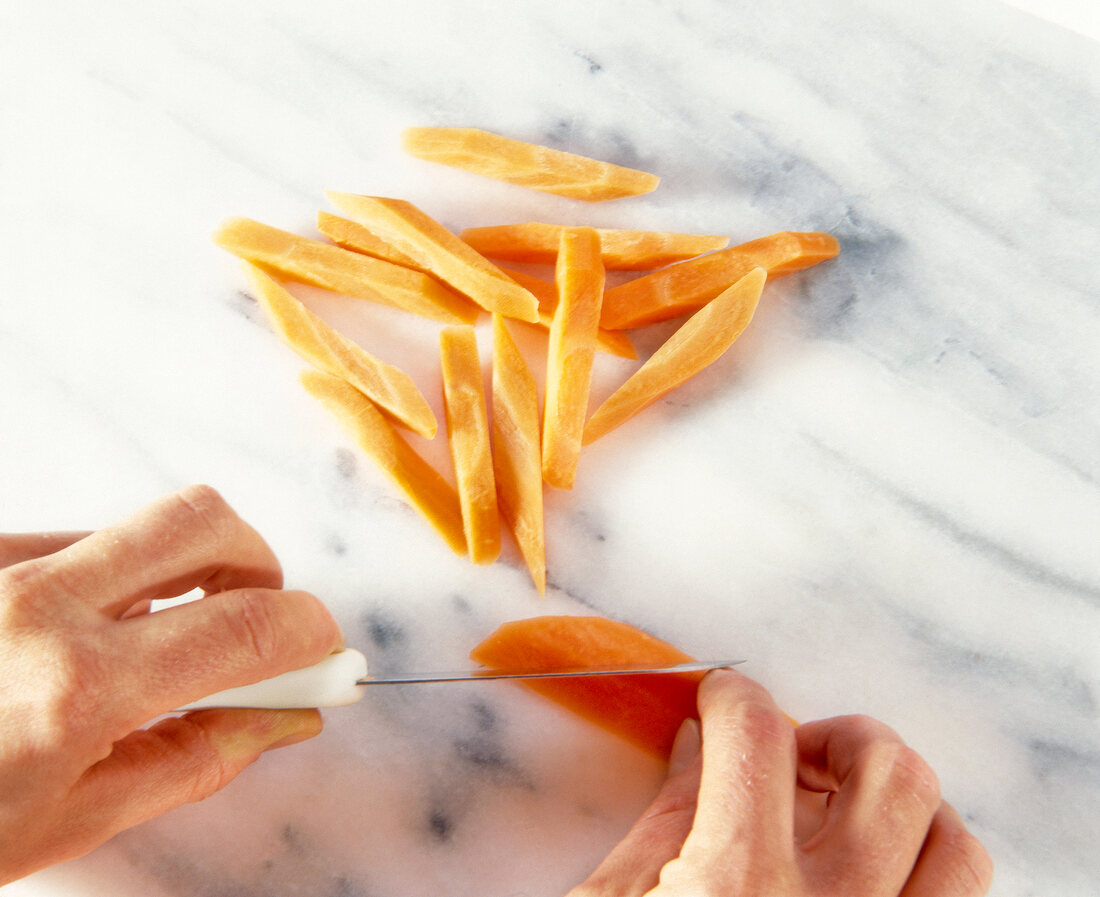 Close-up of carrots cut with knife