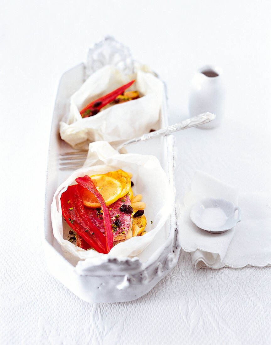 Baked fish with raisin, almonds and balik in serving dish